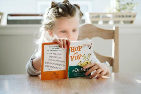 girl reading hop on pop children's book